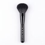 Black powder makeup brush with embellished handle.