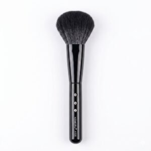 Black powder makeup brush with embellished handle.